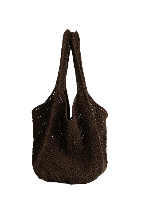 Brown woven handbag on a white background