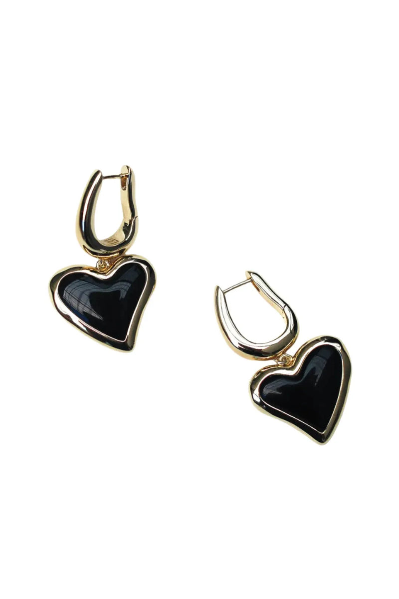 Heart-shaped earrings with black stones on a white background