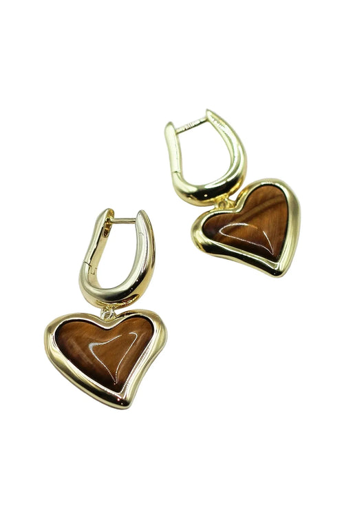 Gold heart-shaped earrings with brown stones on a white background