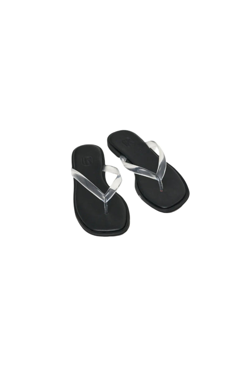 Black sandals with clear straps on a white background