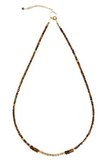 Necklace with brown and gold beads on a white background