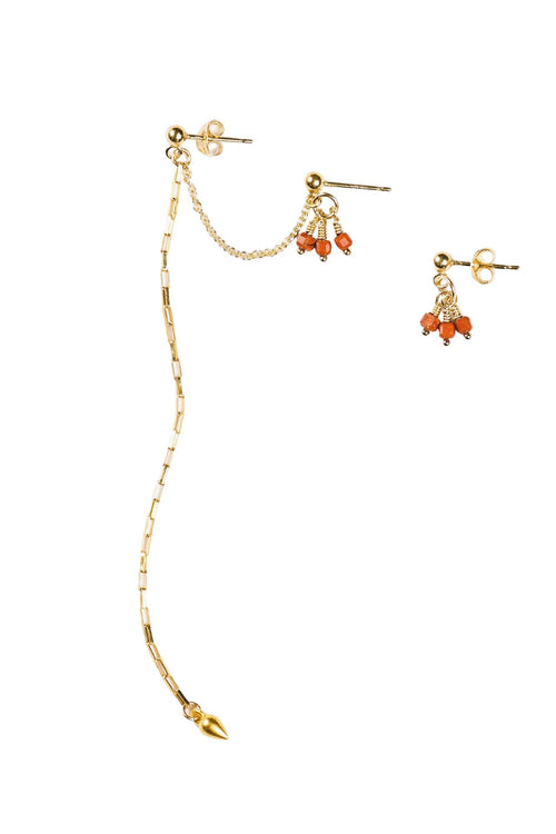 Gold earring set with coral beads on a white background