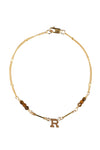 Gold bracelet with letter 'R' charm on a white background