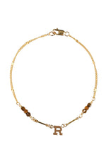 Gold bracelet with letter 'R' charm on a white background