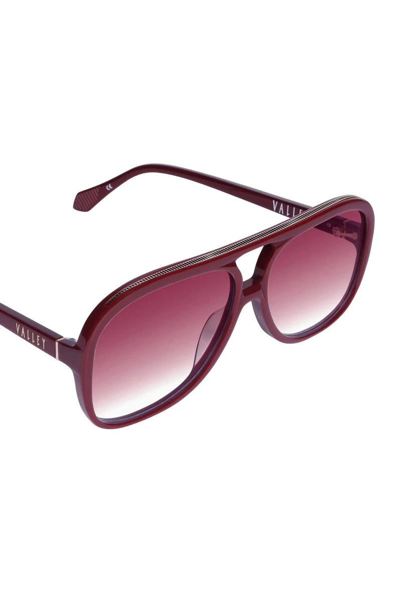 Maroon sunglasses with gradient lenses on a white background