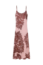 Pink slip dress with coral pattern on a white background