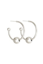 Silver hoop earrings with spherical ends on a white background