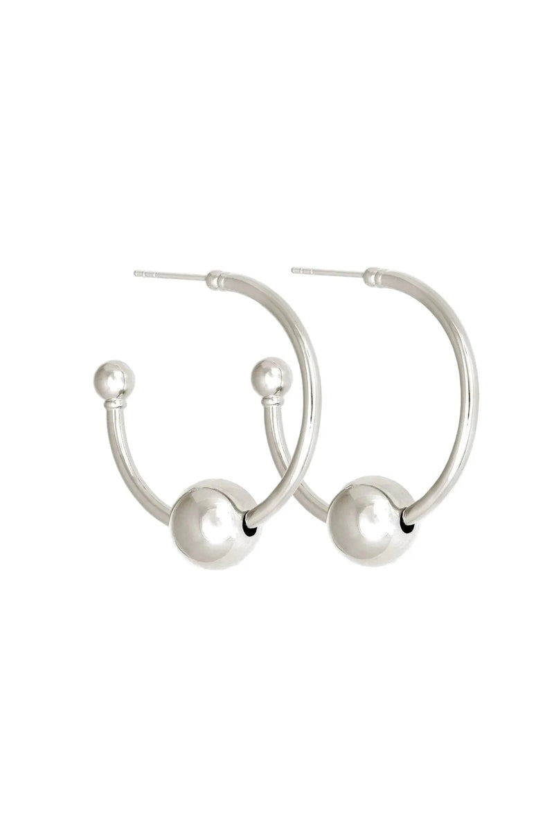 Silver hoop earrings with spherical ends on a white background