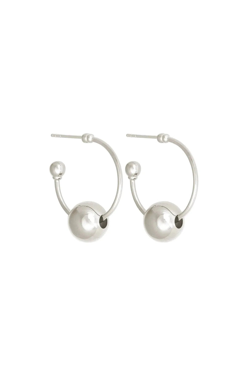Pair of silver hoop earrings with spherical ends on a white background