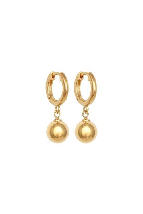 Gold hoop earrings with spherical charms on a white background