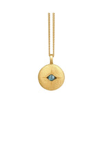 Gold necklace with a round pendant featuring a blue gemstone on a white background