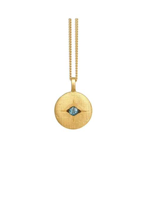 Gold necklace with a round pendant featuring a blue gemstone on a white background