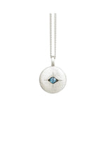 Silver necklace with a round pendant featuring a blue gemstone on a white background