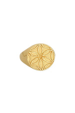 Gold ring with a floral pattern on a white background